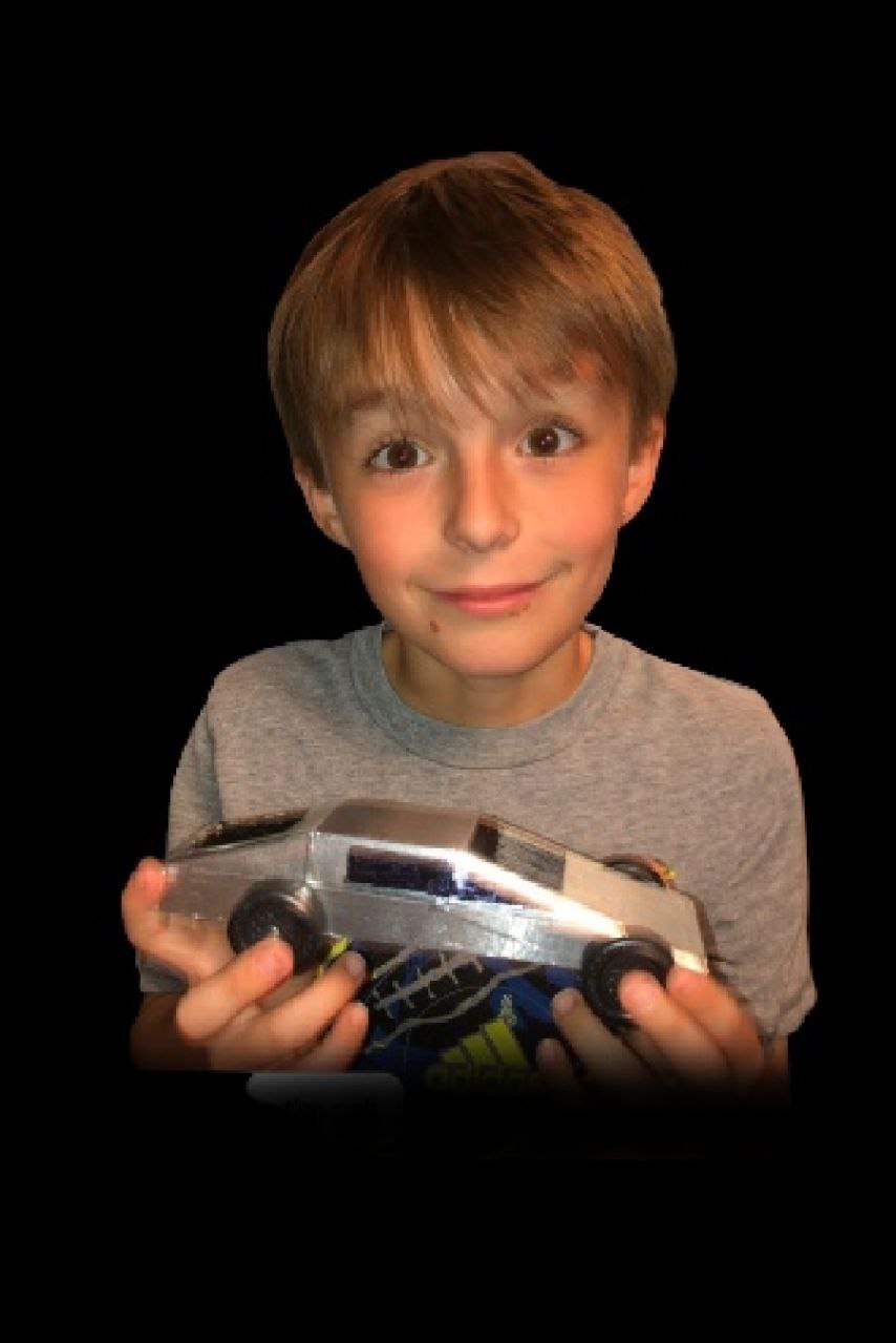 a boy holding a toy car